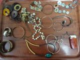a tray that has many different types of jewelry on it