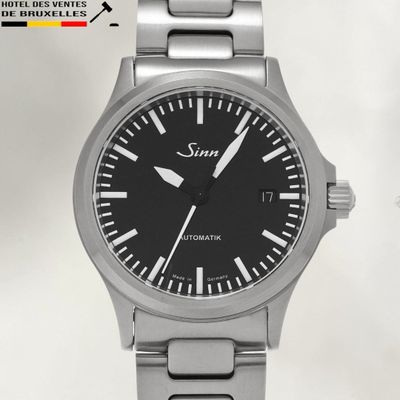 a silver watch with a black face on a white background