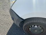 a white truck with a flat tire on the road