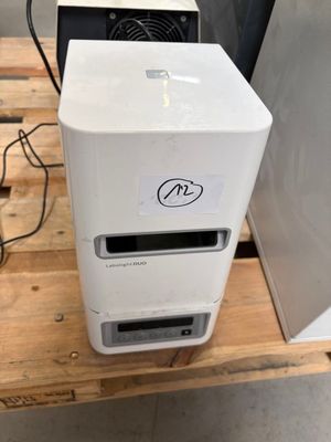 a computer sitting on a wooden pallet in a room