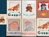 four books on the table with pictures of animals on them