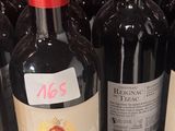 several bottles of wine are lined up on a shelf in a store