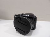 a black camera sitting on a white table