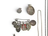 several different types of silver jewelry are displayed on a white surface