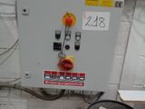 a metal barrel with a sign on it next to an electrical panel