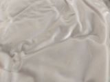 a bed with a white sheet and a pillow on it