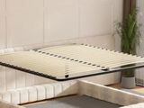 a bed that has a wooden slats on top of it