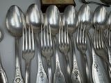 a lot of silver spoons and spoon spoons on the table
