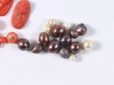 several different types of pearls and corals on a white surface