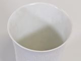 a white cup that is sitting on a table