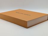 an open brown box with a white lid and a logo on it