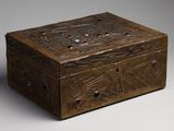 une vieille boîte en bois avec un motif sur le couvercle