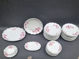 a lot of plates and bowls sitting on a table