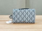 the grey and white cosmetic bag is sitting on a wooden table