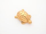 gold plated turtle broochle on a white background