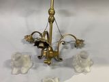 brass plated chandelier with five glass flowers and a candle holder