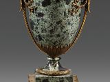 an image of a green vase with two birds on top of it