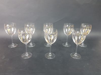 six wine glasses are lined up in a row on a table