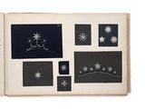 an open book with black and white images of stars and snowflakes