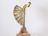 a statue of a woman holding a fan on a marble base