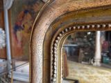 a mirror that is sitting on a table in a room