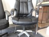 a black office chair and a black office chair in a room