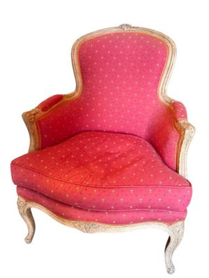 une image représentant une chaise rose aux finitions dorées, avec un coussin rouge