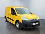 yellow citrole van parked in a large room with a white wall