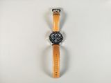 an image of a watch with a leather strap on a white surface