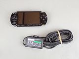a game console and a charger on a table