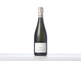 a bottle of wine sitting on top of a white table