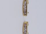 a pair of diamond earrings on a white surface