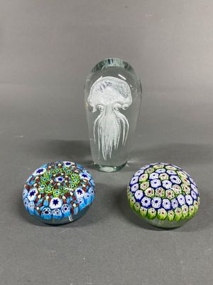 three glass vases sitting on top of a table next to each other
