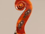 an old violin with a long neck and a long bow