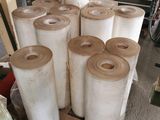 several rolls of paper are stacked on a pallet in a warehouse