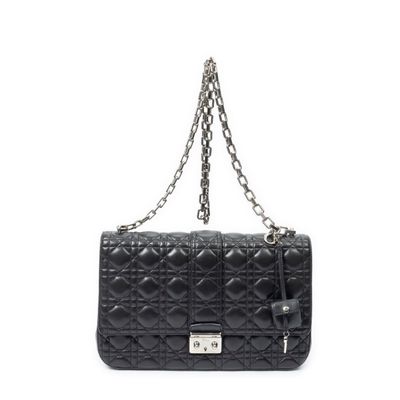 a black quilted bag with a chain hanging from the front