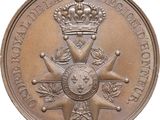 an image of a bronze medal with a crown on top of it