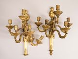 pair of antique brass wall sconces on a white wall