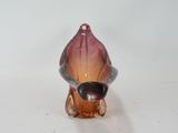 a glass figurine of a shell on a white surface