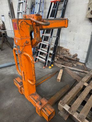 une grande machine orange qui se trouve dans un entrepôt