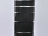 a large black vase sitting on a stand on a white surface