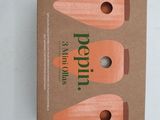 three carrots in a cardboard box on a white surface