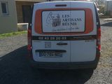 a van that is parked in front of a house