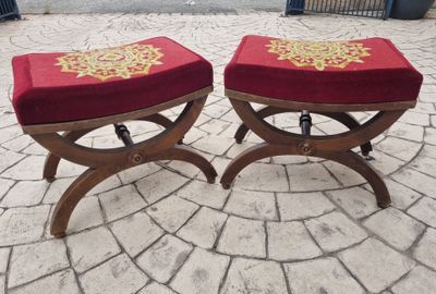 two red stools with gold designs on them