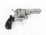 an old revolver on a white surface with a black handle