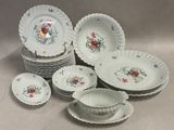 a lot of plates and bowls sitting on a table