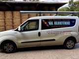 a van that is parked in front of a hay bale