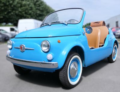a small blue car that is parked in a parking lot