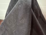 a close up of a piece of black fabric on a wooden floor
