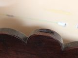 a close up of a wooden heart shaped object on a table